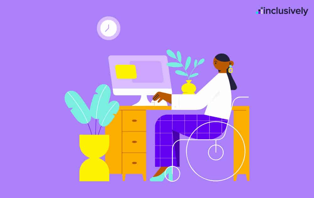 Woman in wheelchair sitting at desk utilizing desktop