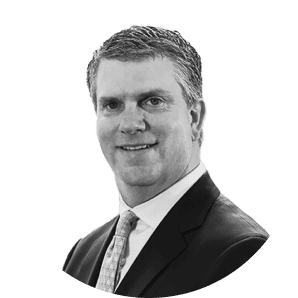 A man with short hair wearing a suit and tie.