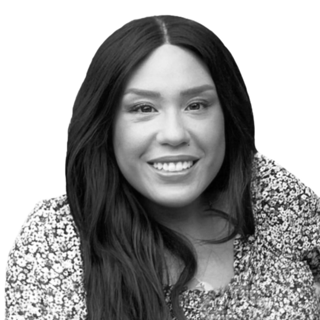 Tiffany Meehan, a smiling light skinned Latina with dark long hair and wearing a floral dress.